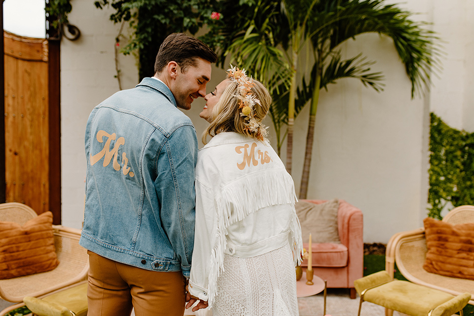  retro boho wedding with amber and brown color scheme – couple kissing in jackets