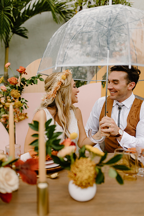  retro boho wedding with amber and brown color scheme – couple with umbrella