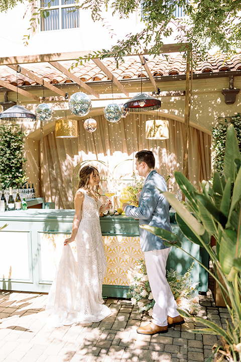  a colorful wedding inspired by the Amalfi Coast with the groom in different wedding day looks - bar 