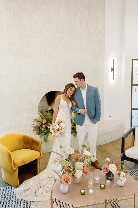  a colorful wedding inspired by the Amalfi Coast with the groom in different wedding day looks – couple embracing, groom in blue suit 