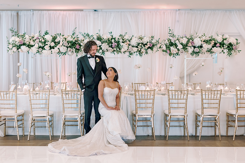  a Bridgerton inspired wedding with grand florals and dainty details – couple at the reception 