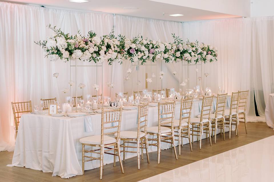  a Bridgerton inspired wedding with grand florals and dainty details – reception table 