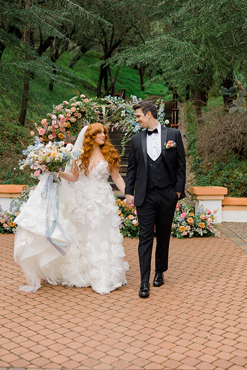  a colorful wedding with black tie style – couple walking 