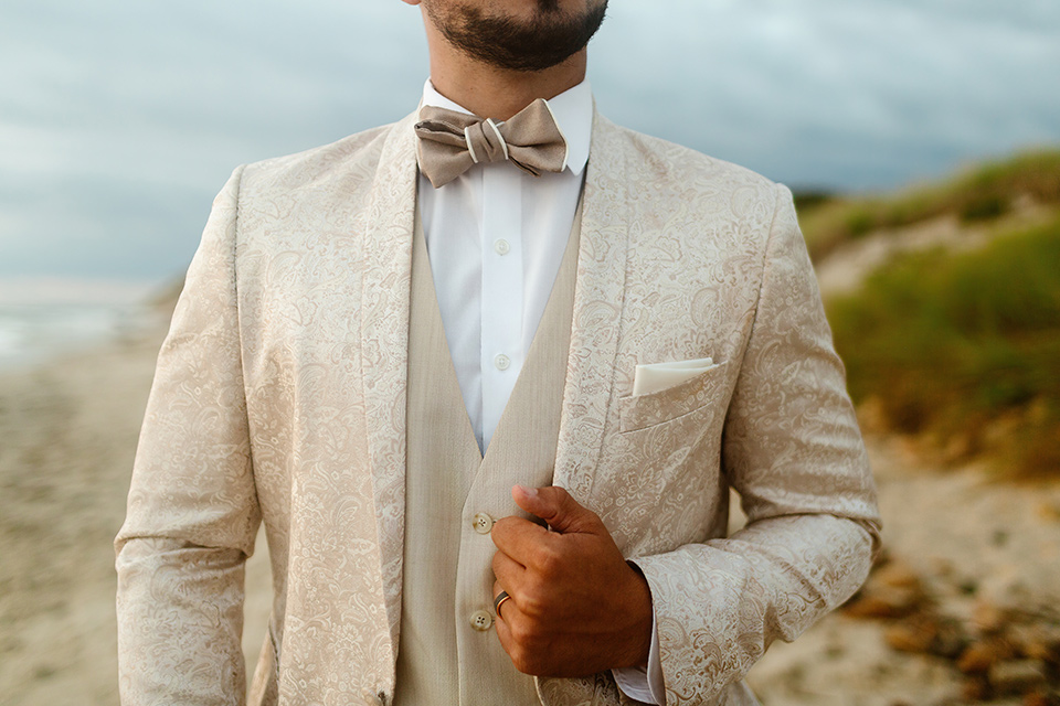  a neutral beachy elopement with the groom in a tan suit and the bride in a white lace dress – groom coat 