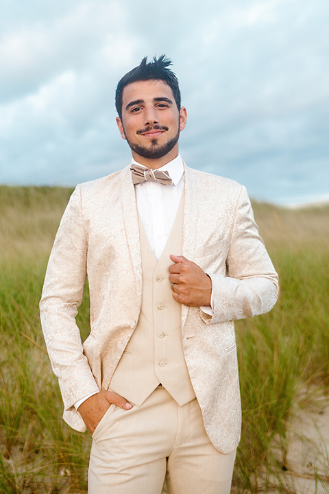  a neutral beachy elopement with the groom in a tan suit and the bride in a white lace dress – groom 