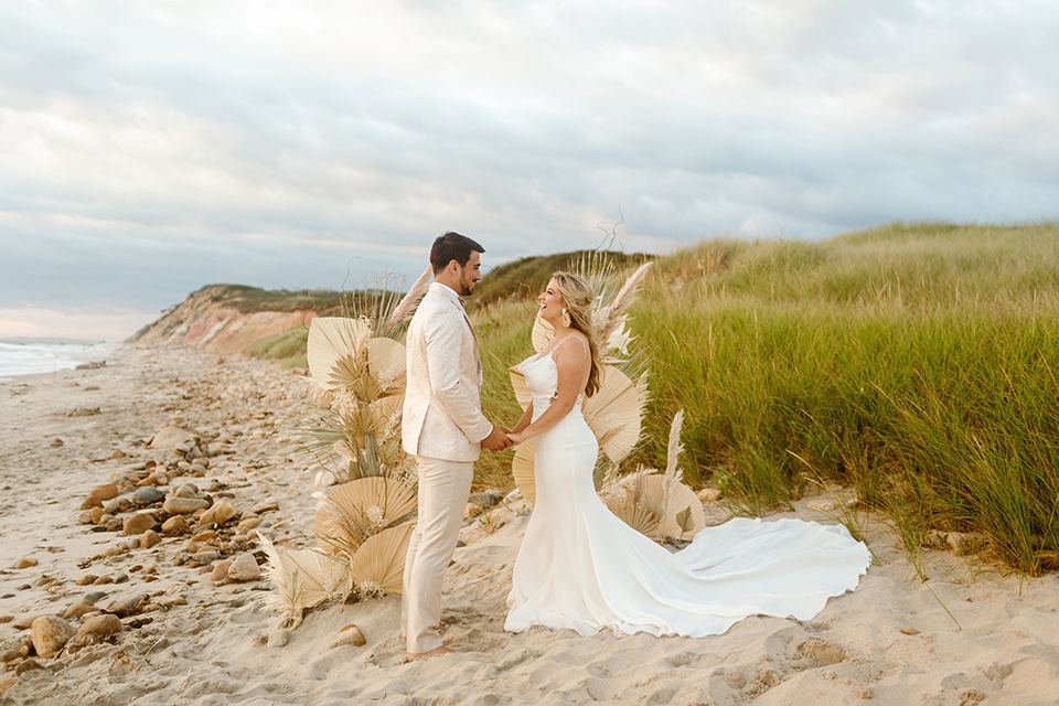  a neutral beachy elopement with the groom in a tan suit and the bride in a white lace dress – ceremony 