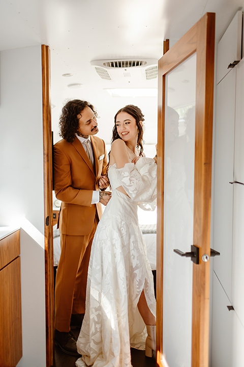  a boho caramel wedding inspo with an airstream and pampas grass – couple getting ready together 