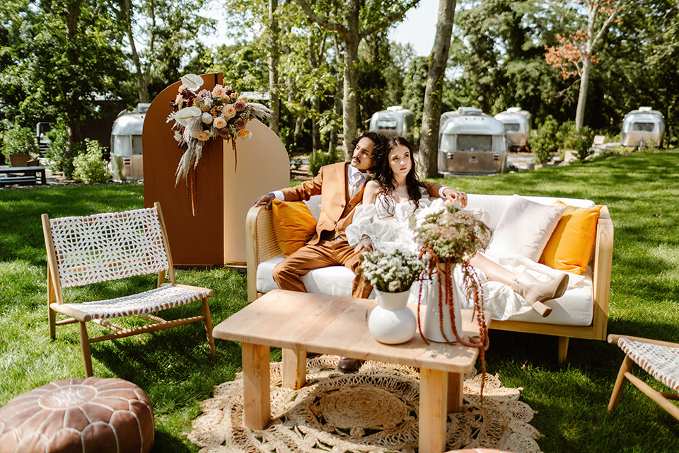  a boho caramel wedding inspo with an airstream and pampas grass – couple on the couch 