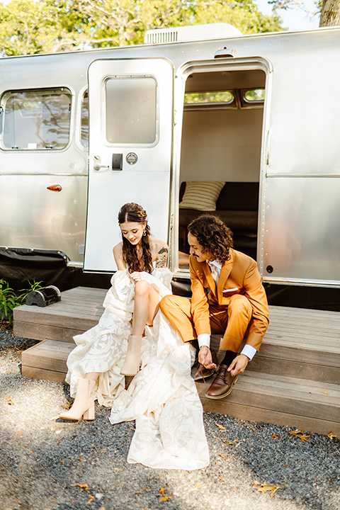  a boho caramel wedding inspo with an airstream and pampas grass – putting shoes on 