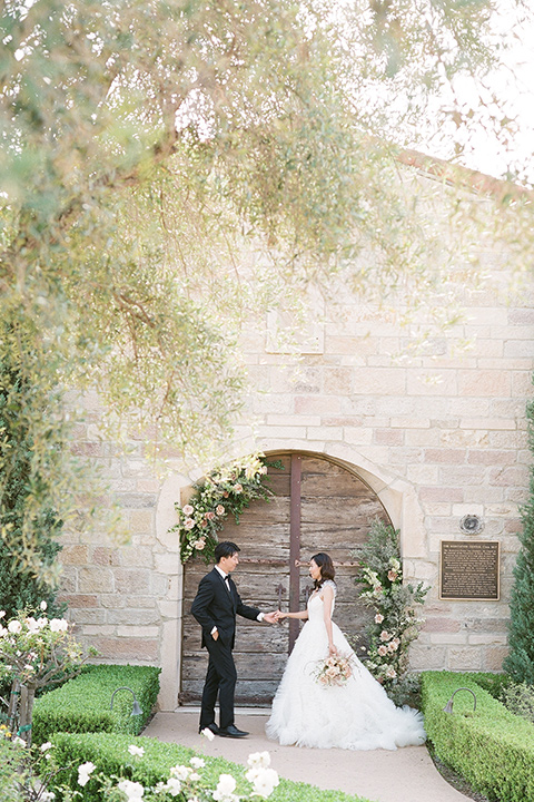  a European romantic wedding with an old world ethereal vibe – couple walking holding hands 