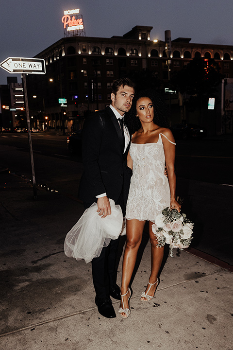  downtown Los Angeles elopement with the bride in a mini dress and the groom in a black tuxedo – couple looking at each other 