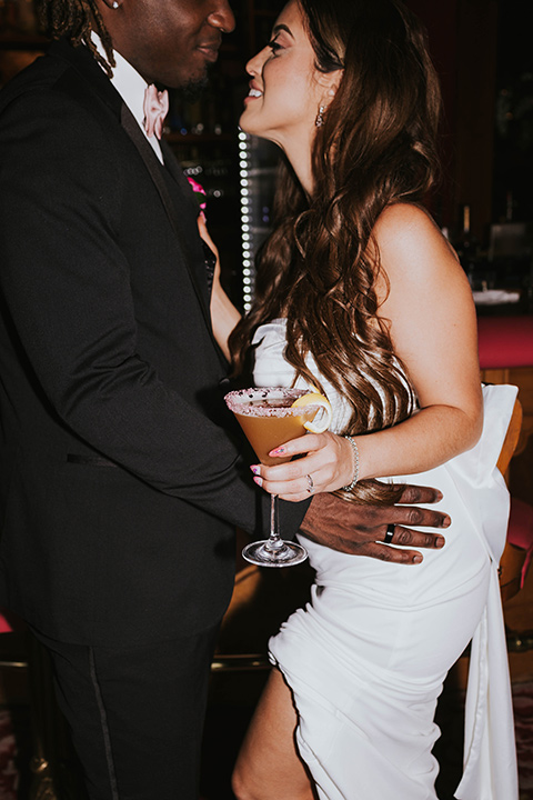  a grand pink and rose las vegas style wedding with bold trendy details – couple at the bar 