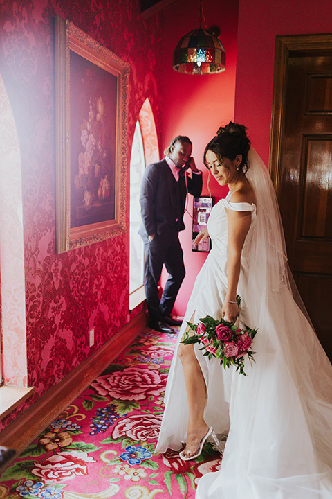  a grand pink and rose las vegas style wedding with bold trendy details – couple by the window 
