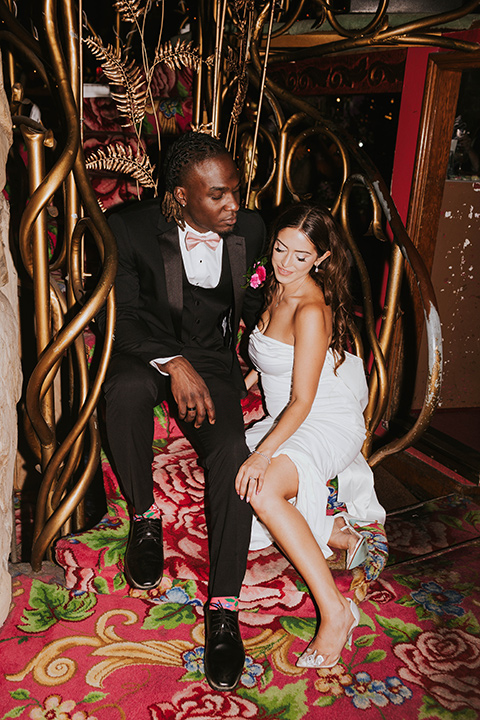  a grand pink and rose las vegas style wedding with bold trendy details – couple sitting on the stairs 