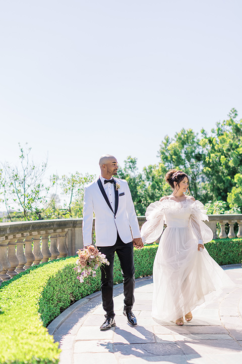  luxury wedding at Greystone Mansion with a classic design scheme - couple walking around the mansion 