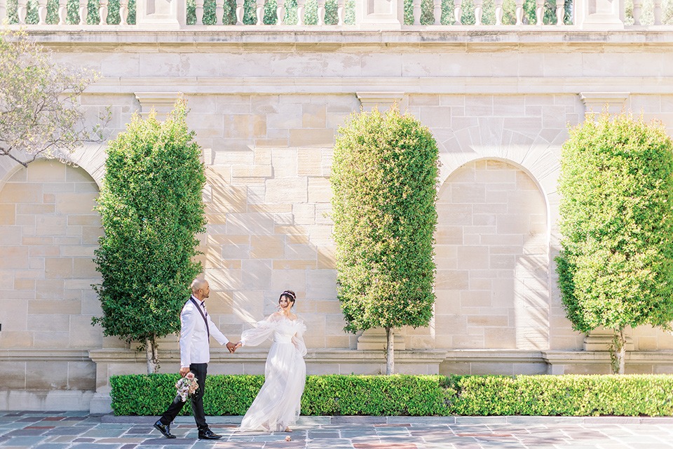  luxury wedding at Greystone Mansion with a classic design scheme - couple walking 