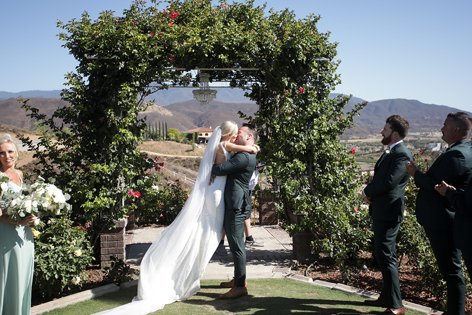 a green toned wedding with an outdoor venue - first kiss 