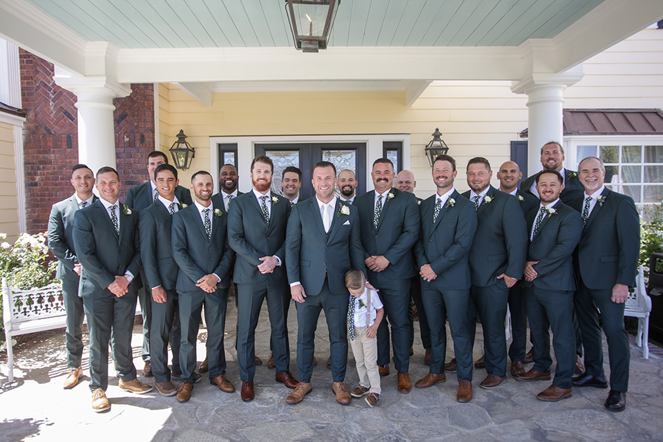  a green toned wedding with an outdoor venue - groomsmen 