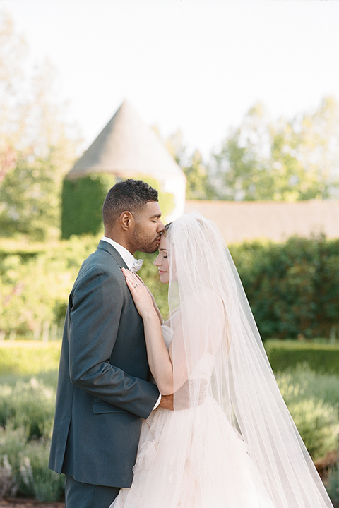  a dreamy garden wedding at Kestrel Park with the groom in a Navy Shawl tuxedo - couple by the flowers 