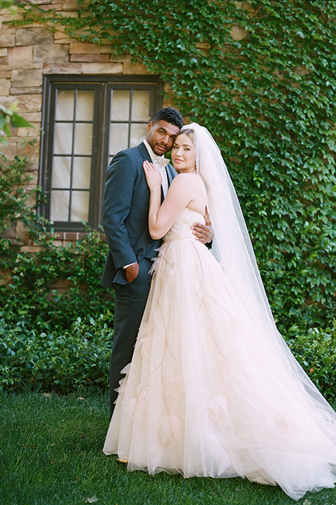  a dreamy garden wedding at Kestrel Park with the groom in a Navy Shawl tuxedo - couple outside the venue 