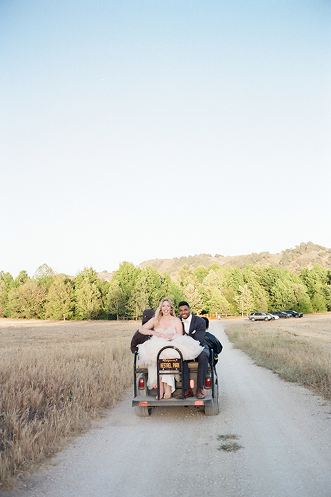  a dreamy garden wedding at Kestrel Park with the groom in a Navy Shawl tuxedo - couple in the car 