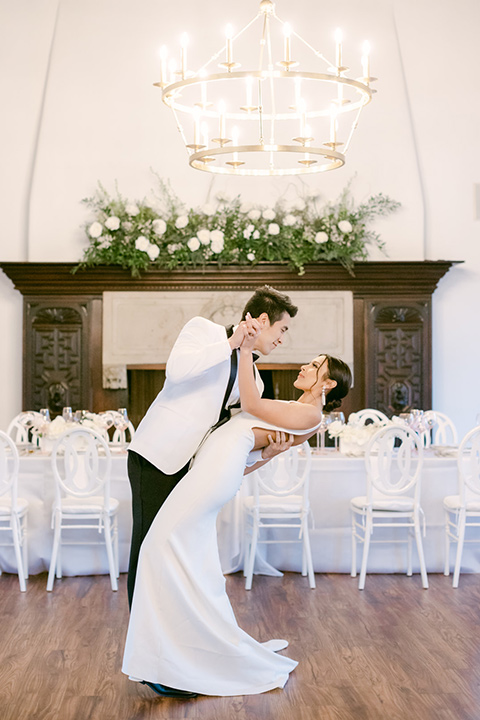  a monochromatic modern wedding at La Venta Inn with the bride in a sleek gown and the groom in a white tuxedo - couple in the reception 