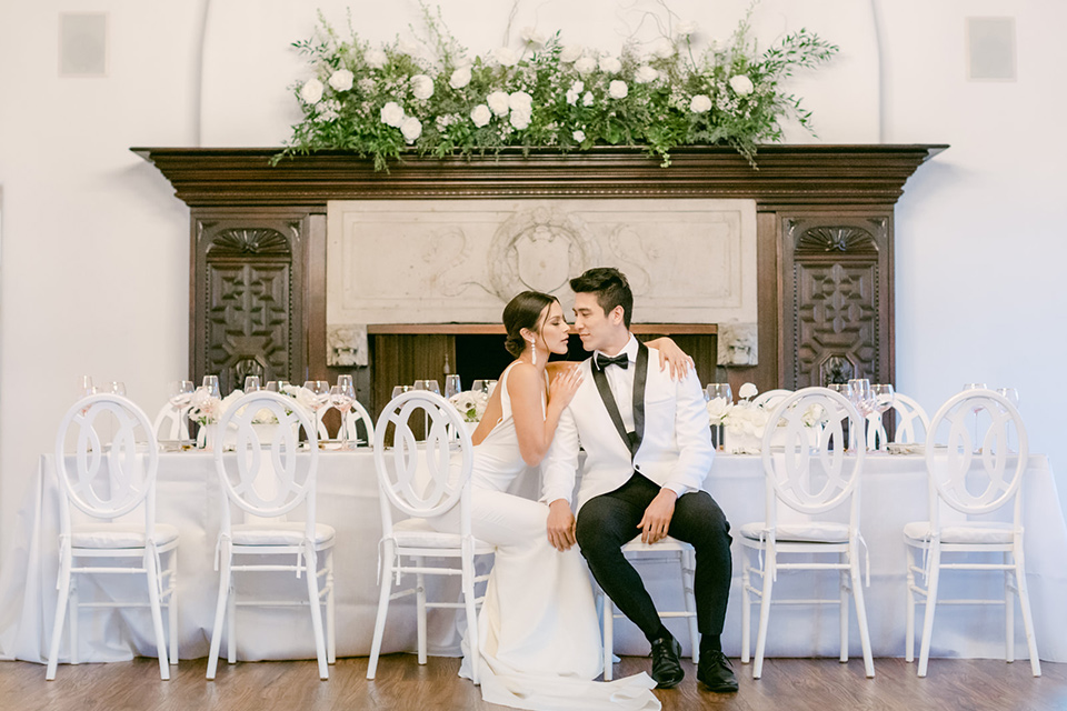  a monochromatic modern wedding at La Venta Inn with the bride in a sleek gown and the groom in a white tuxedo - couple in reception 