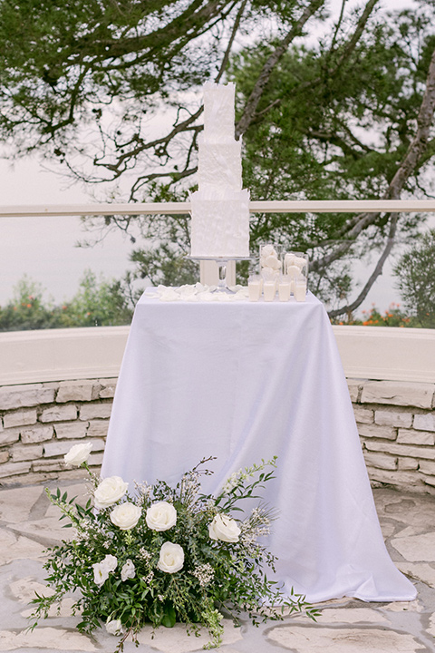  a monochromatic modern wedding at La Venta Inn with the bride in a sleek gown and the groom in a white tuxedo - cake 