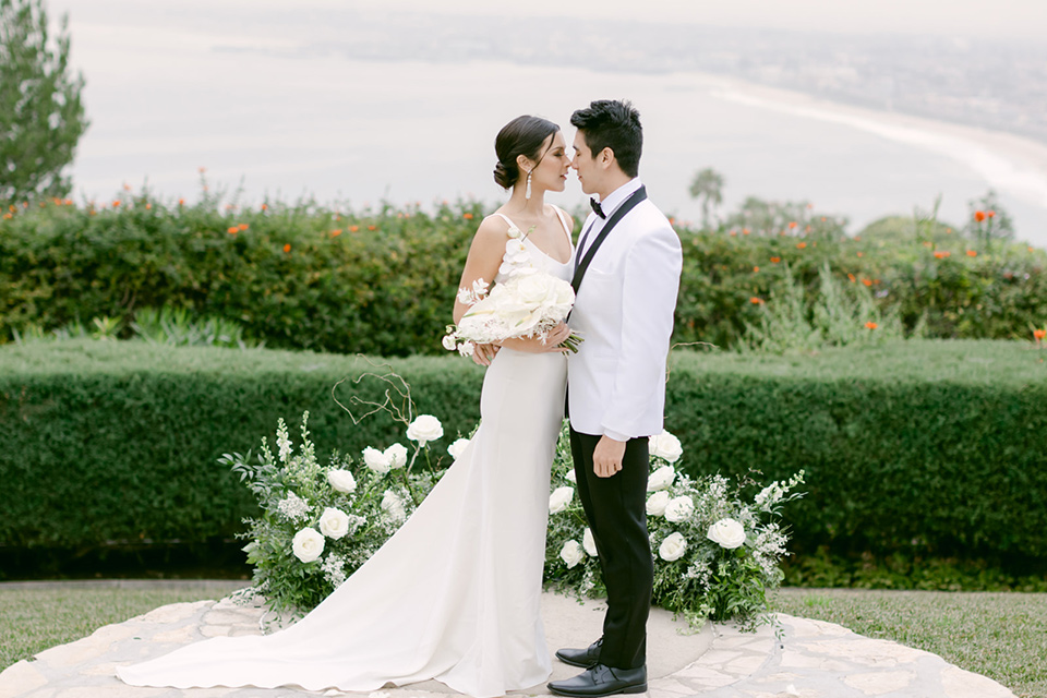  a monochromatic modern wedding at La Venta Inn with the bride in a sleek gown and the groom in a white tuxedo - cocktail 