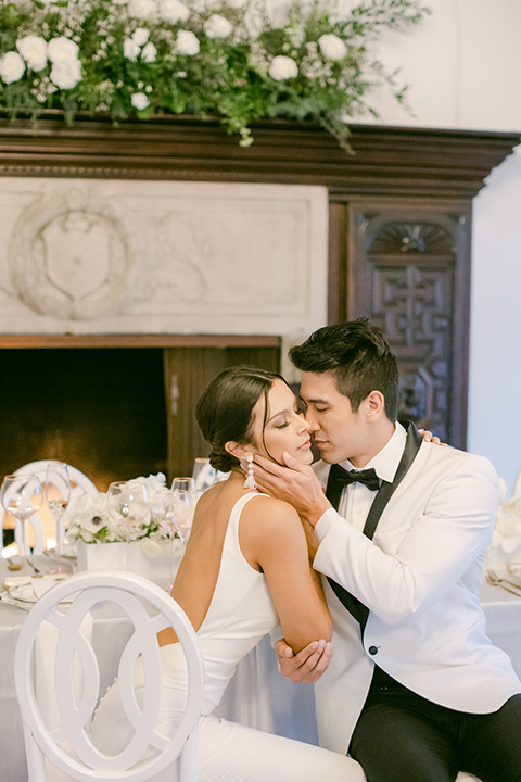  a monochromatic modern wedding at La Venta Inn with the bride in a sleek gown and the groom in a white tuxedo - couple in the reception 