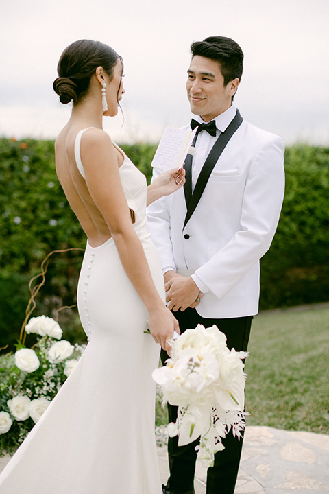  a monochromatic modern wedding at La Venta Inn with the bride in a sleek gown and the groom in a white tuxedo - ceremony 