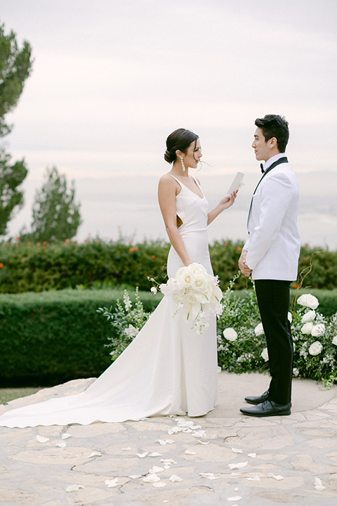  a monochromatic modern wedding at La Venta Inn with the bride in a sleek gown and the groom in a white tuxedo - ceremony 