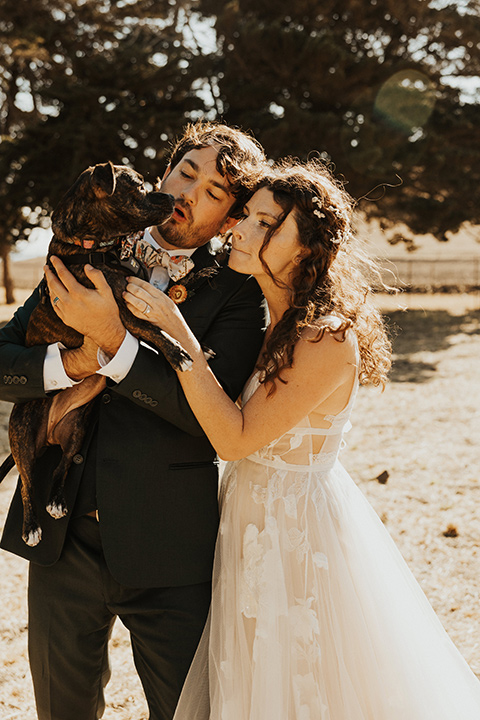  green and orange wedding in the woods with a rustic bohemian vibe – couple with puppy 