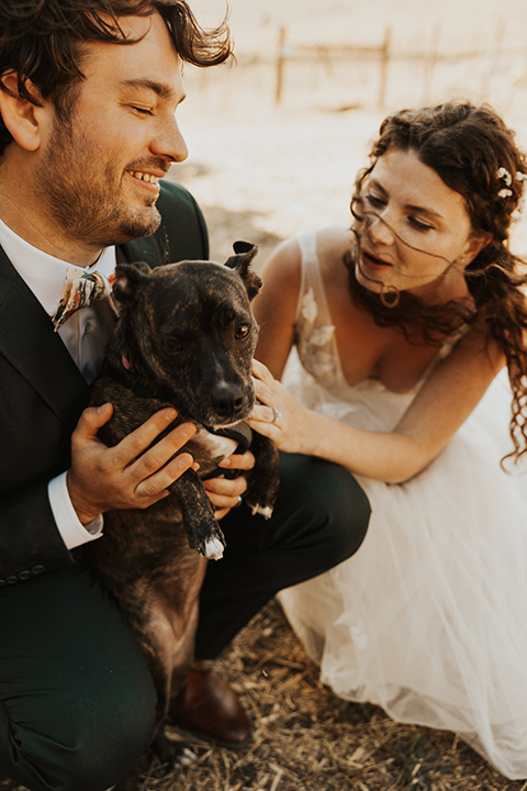  green and orange wedding in the woods with a rustic bohemian vibe – couple with puppy 