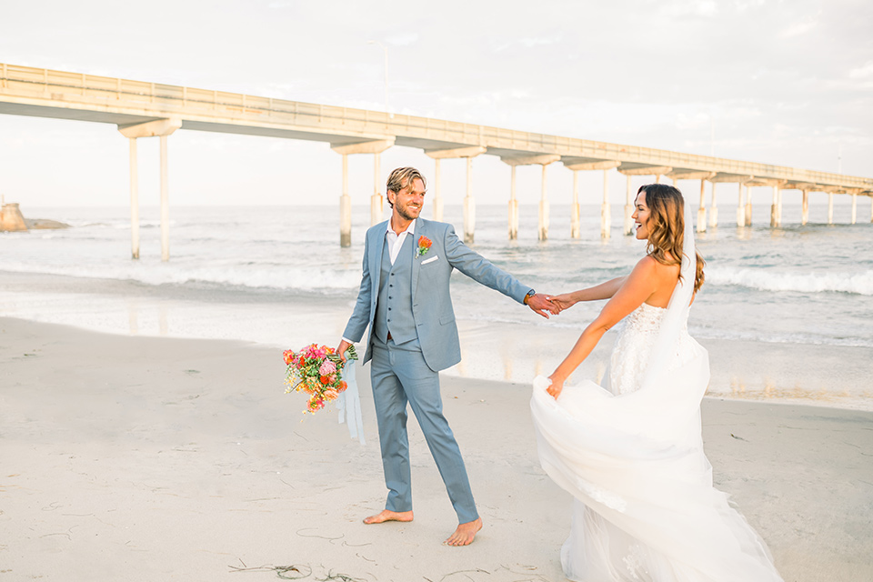  couple eloping on the beach with bright vibrant colors - walking away 