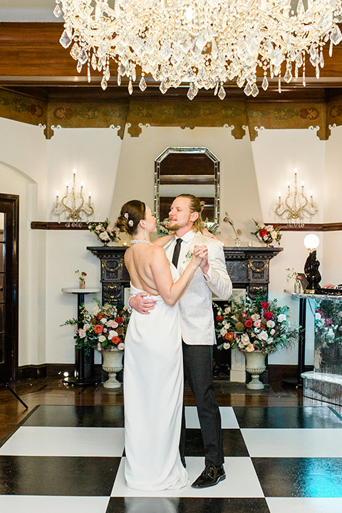 a dreamy whimsical wedding at a castle venue with the groom in a green velvet coat and the bride in a ballgown – first dance 