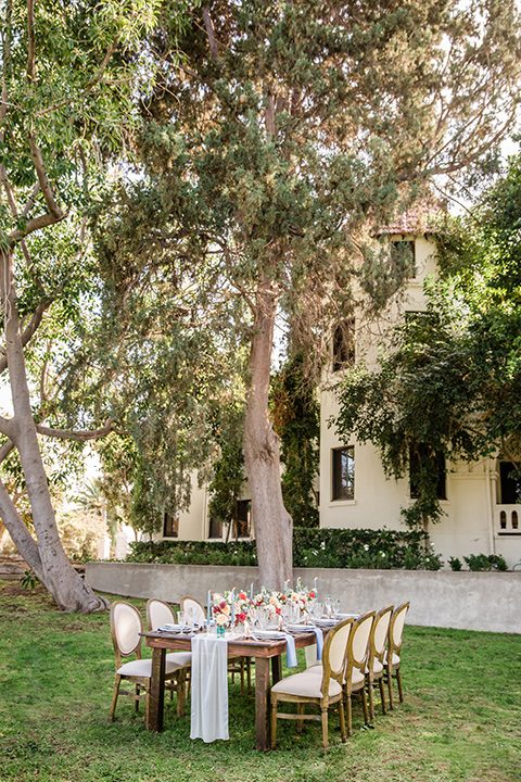  a dreamy whimsical wedding at a castle venue with the groom in a green velvet coat and the bride in a ballgown – tablescape and décor 