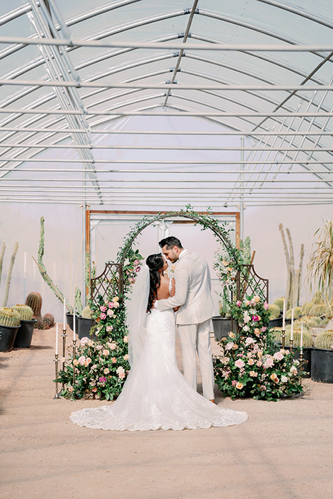  a garden romance wedding inspo with the bride in a luxe lace gown and the groom in a tan suit - ceremony 